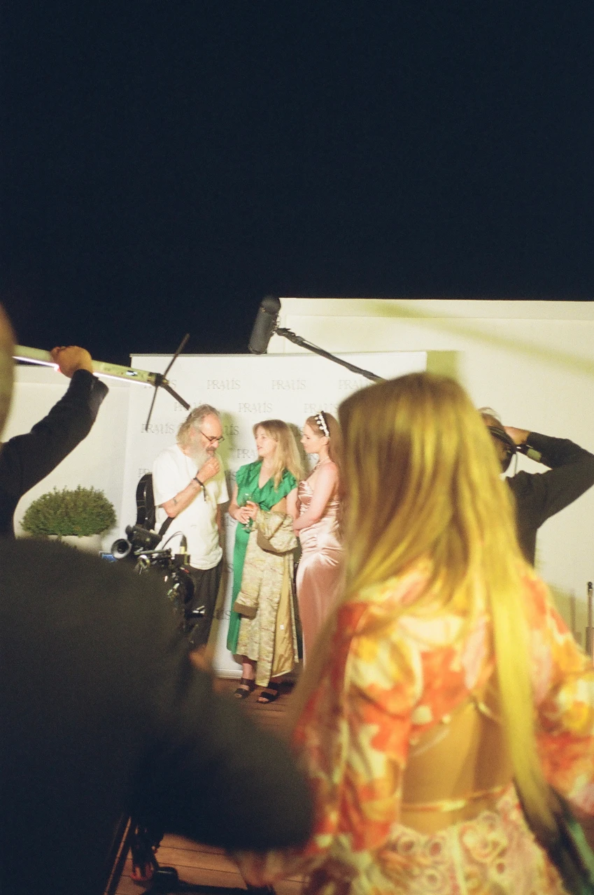 Guests gathered on a terrace at night.